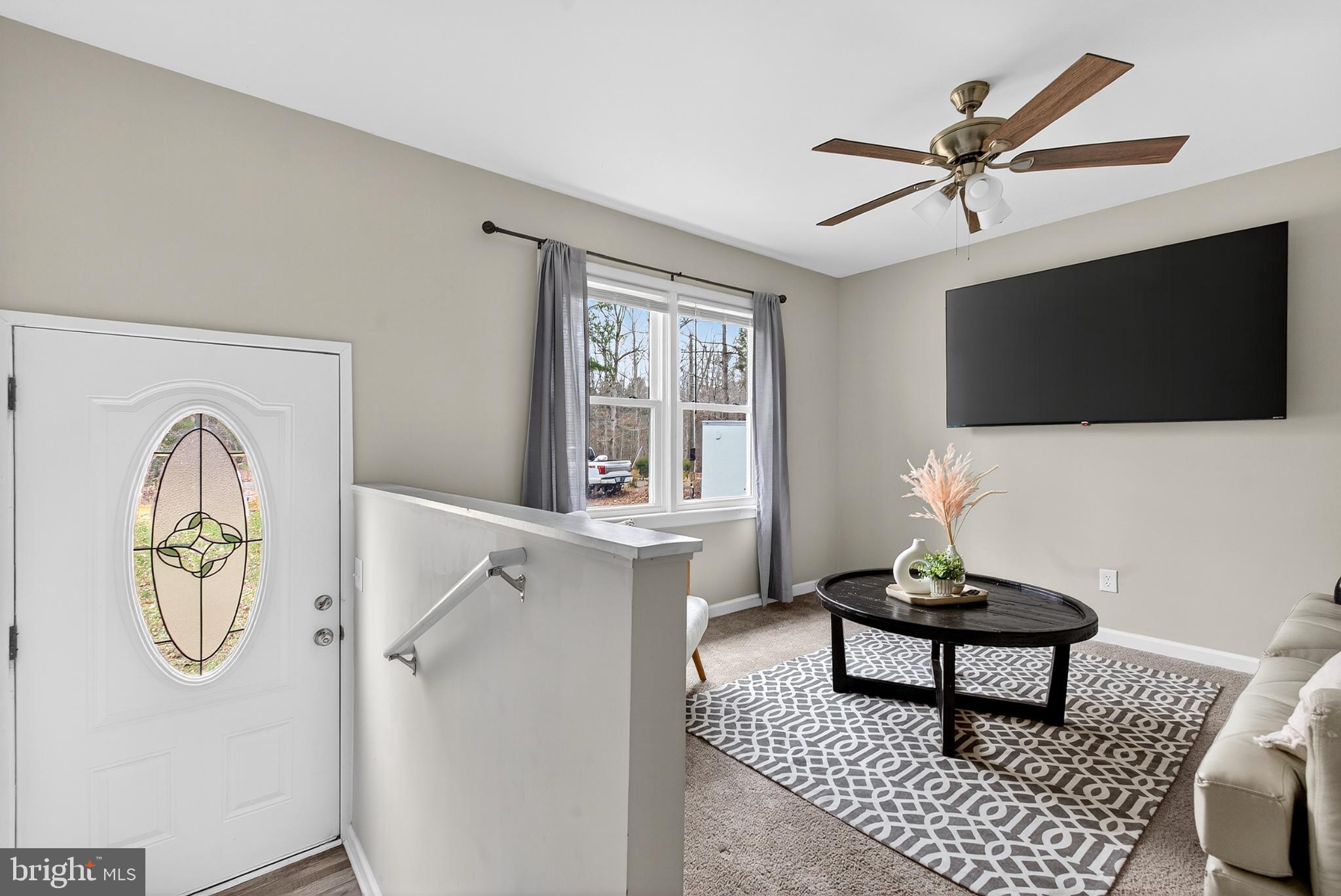 20045 Courtney Road Hanover, VA 23069 - Photo 3 of 21 a living room with furniture a flat screen tv and a window