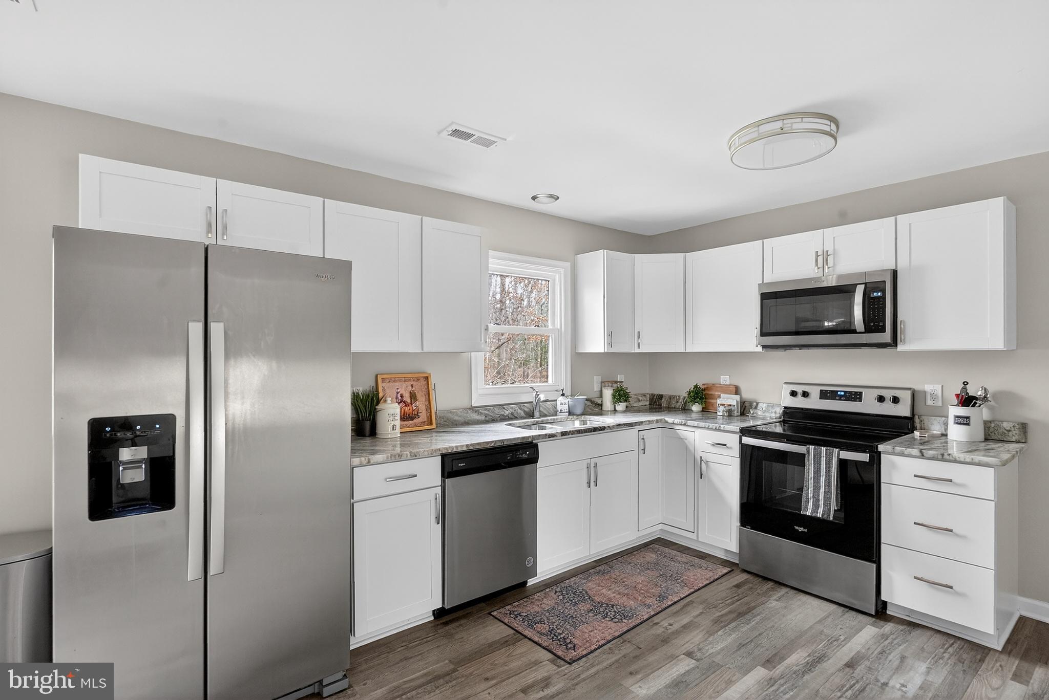 20045 Courtney Road Hanover, VA 23069 - Photo 7 of 21 a kitchen with white cabinets and stainless steel appliances