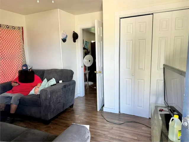 a living room with furniture and a closet