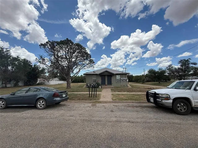 a view of a car parked in back of a house