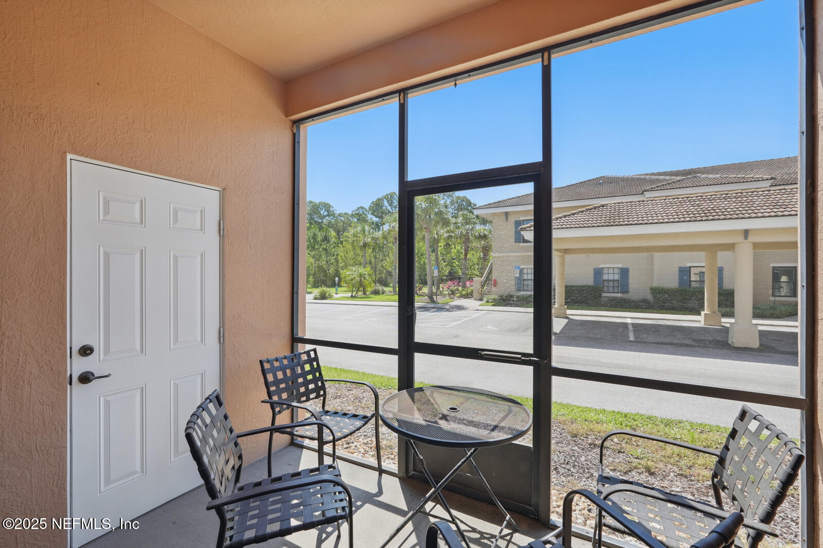 a view of a living room with furniture and floor to ceiling windows