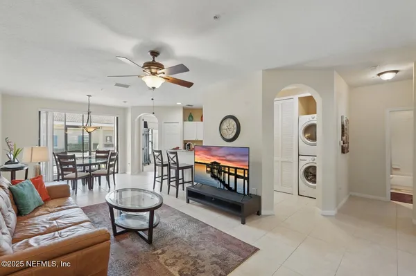 a view of living room filled with furniture and a chandelier