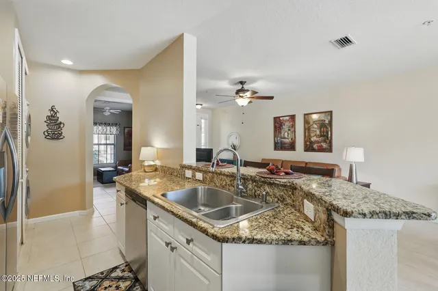 a kitchen with stainless steel appliances granite countertop a sink stove and cabinets