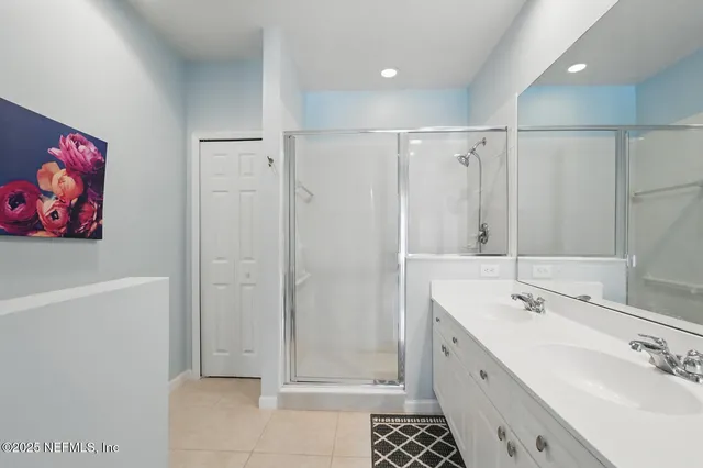 a bedroom with two beds and painting on the wall