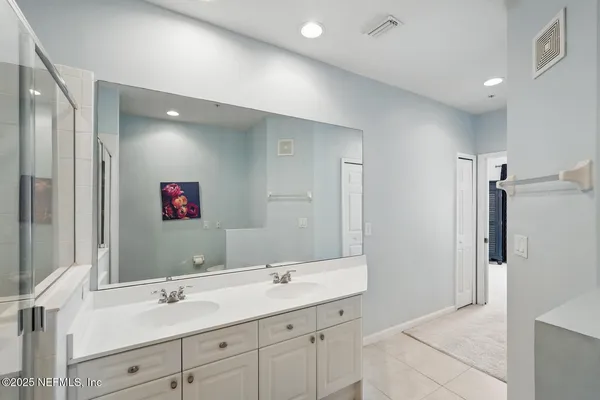 a bedroom with two beds and painting on the wall