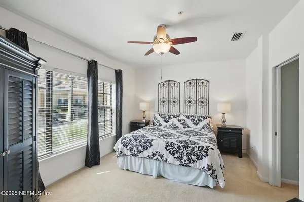 a bedroom with a large bed and a window