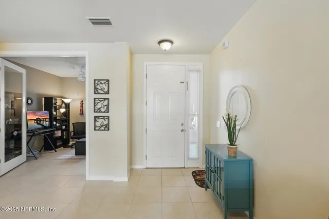 a view of living room filled with furniture and a chandelier