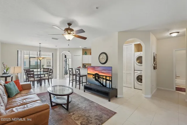 a living room with furniture a table and a chandelier