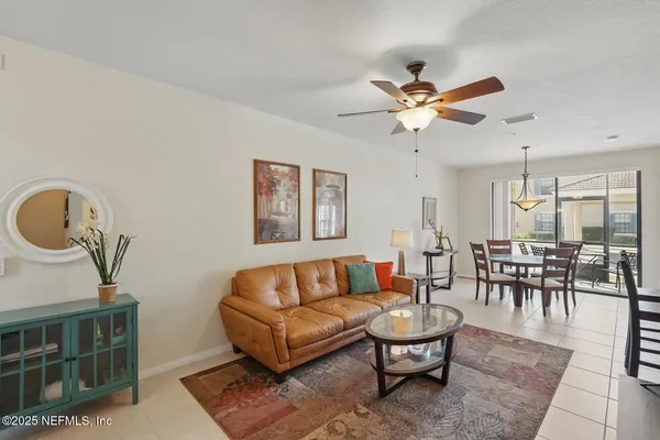 a living room with furniture and a lamp