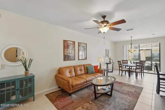 a living room with furniture and a lamp
