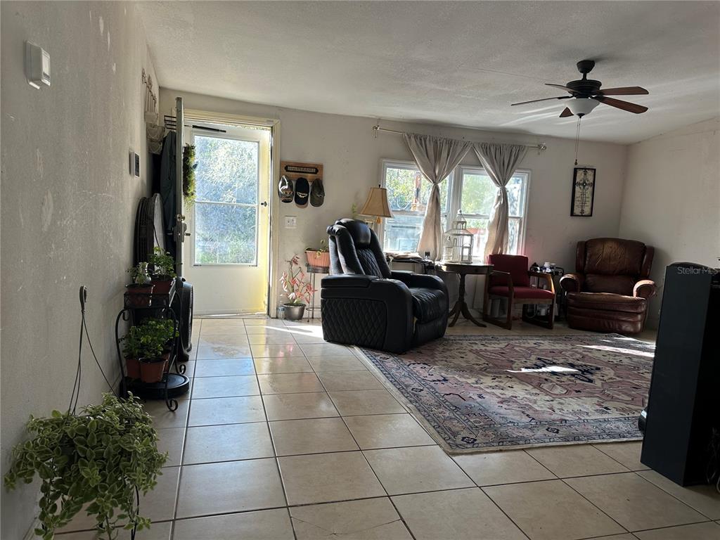 212 Ballard Road Avon Park, FL 33825 - Photo 12 of 22 a living room with patio furniture and a large window