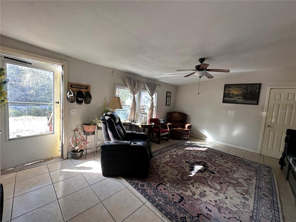 212 Ballard Road Avon Park, FL 33825 - Photo 14 of 22 a living room with furniture gym equipment and a window