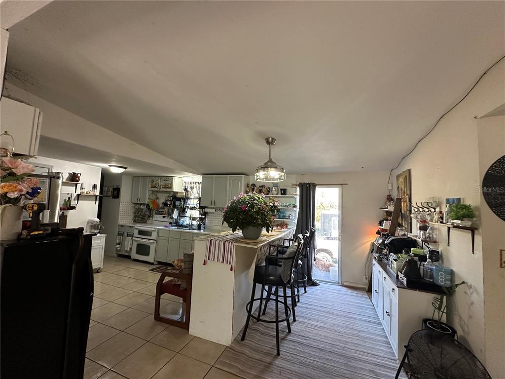 212 Ballard Road Avon Park, FL 33825 - Photo 8 of 22 a view of a dining room with furniture and wooden floor