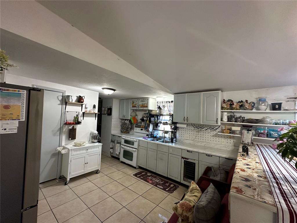 212 Ballard Road Avon Park, FL 33825 - Photo 9 of 22 a kitchen with white cabinets and white appliances