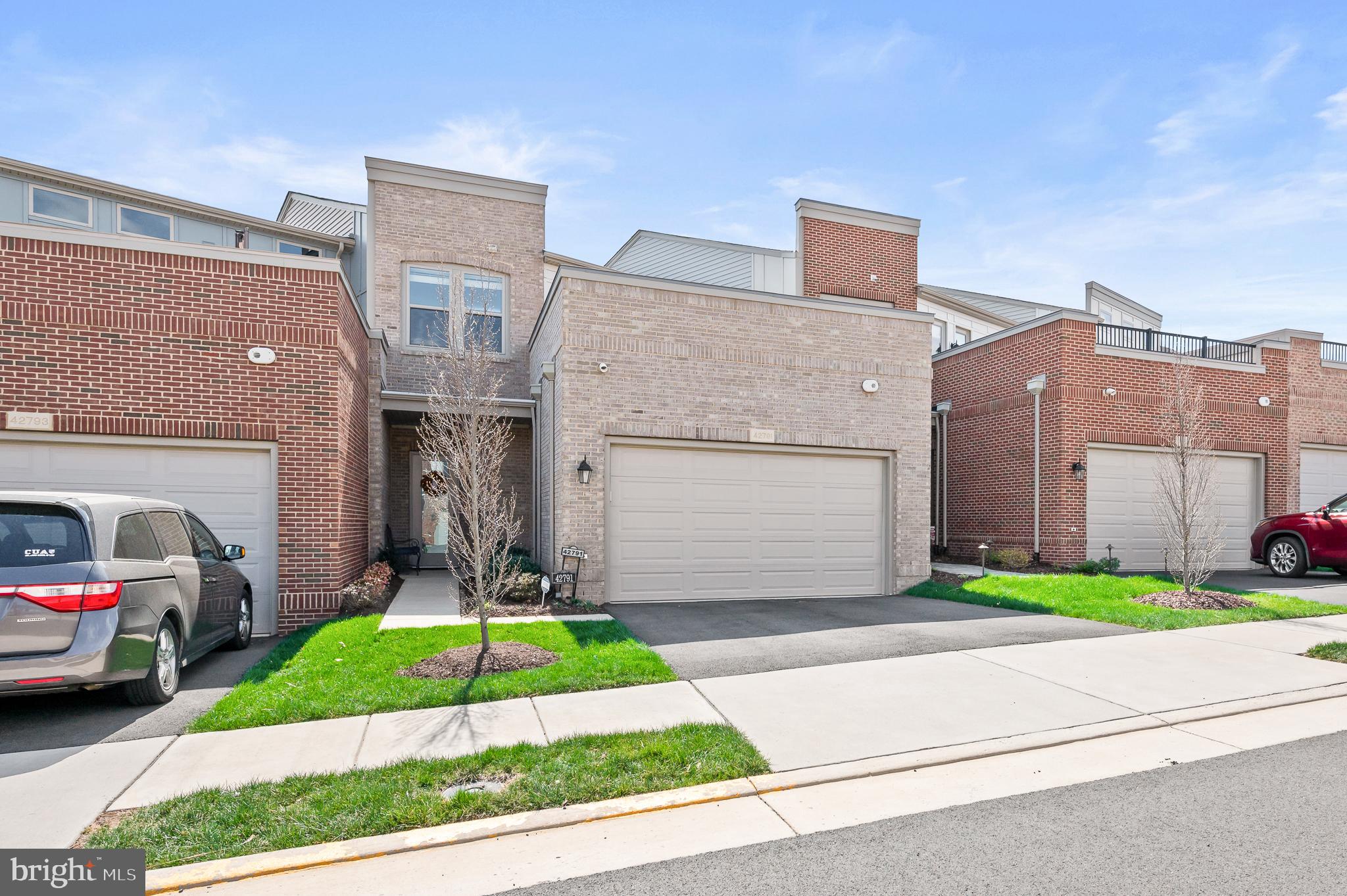 42791 Macbeth Terrace Ashburn, VA 20148 - Photo 1 of 63 a front view of a house with a yard and garage