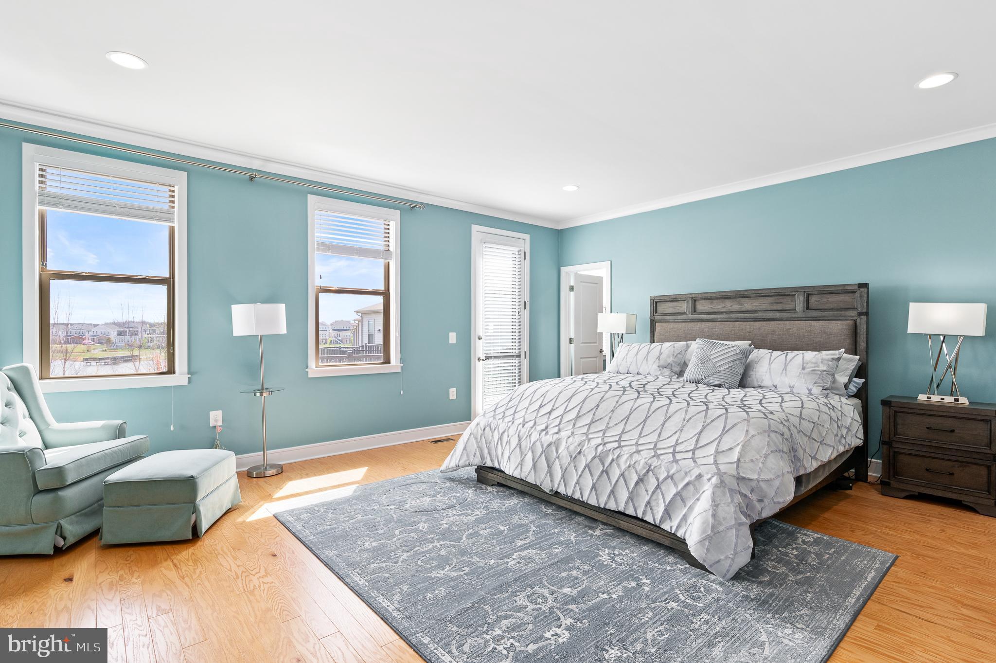 42791 Macbeth Terrace Ashburn, VA 20148 - Photo 22 of 63 a bedroom with a bed and wooden floor