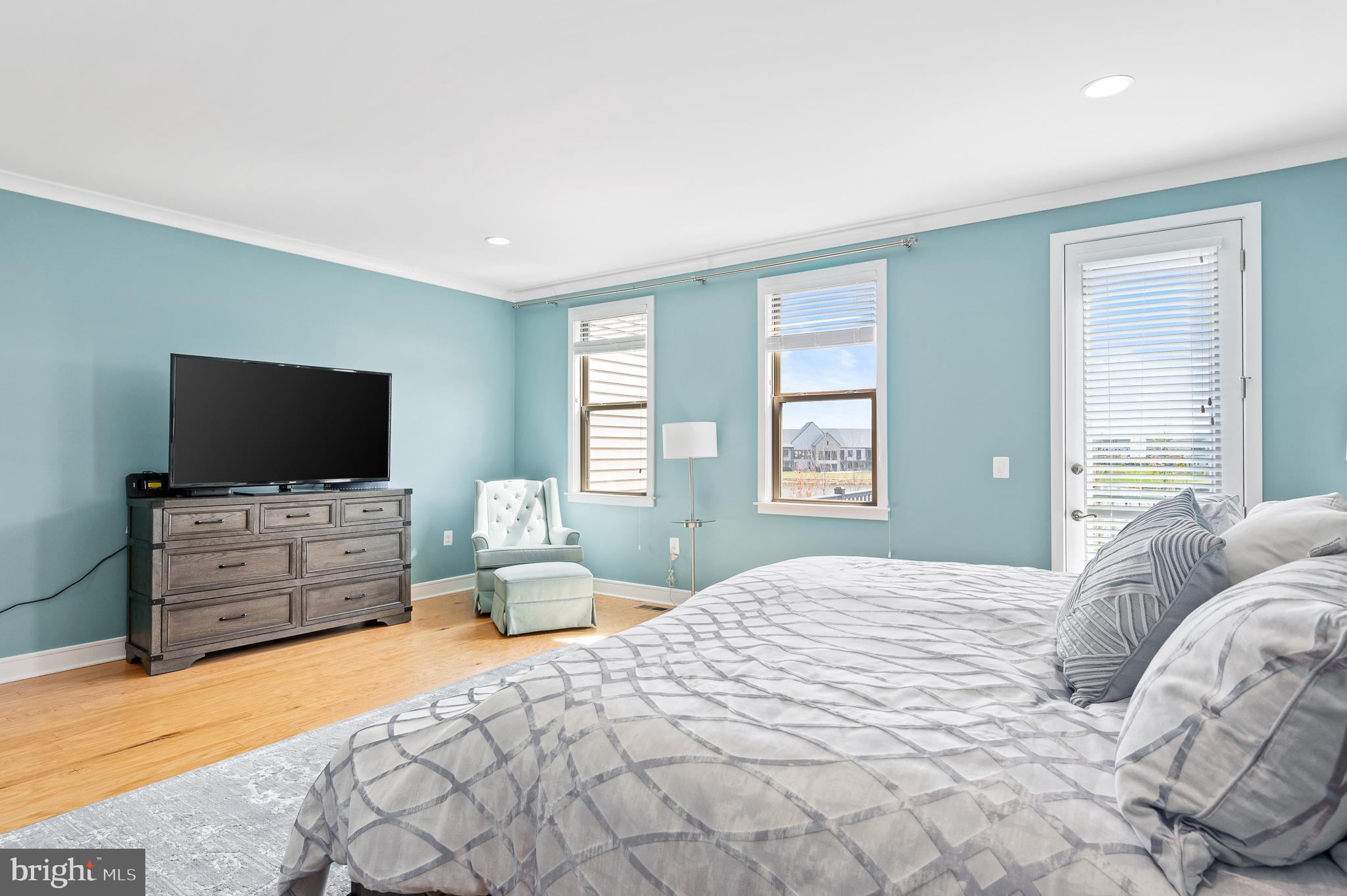 42791 Macbeth Terrace Ashburn, VA 20148 - Photo 24 of 63 a bedroom with a bed and a flat screen tv