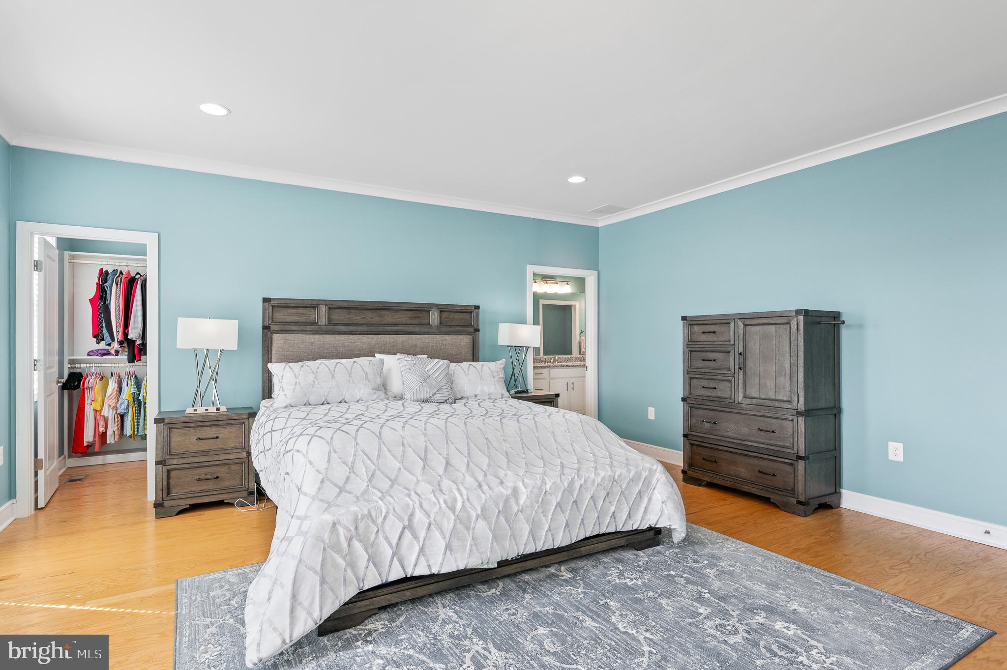42791 Macbeth Terrace Ashburn, VA 20148 - Photo 29 of 63 a bedroom with a bed and wooden floor