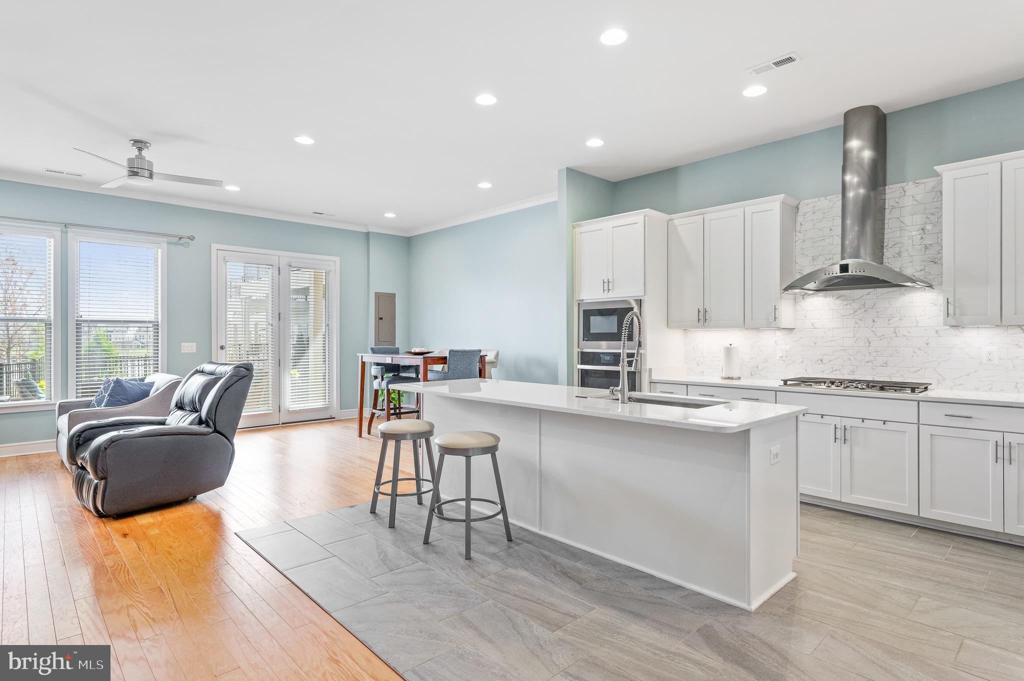 42791 Macbeth Terrace Ashburn, VA 20148 - Photo 63 of 63 a kitchen with stainless steel appliances granite countertop a stove a sink a dining table and chairs