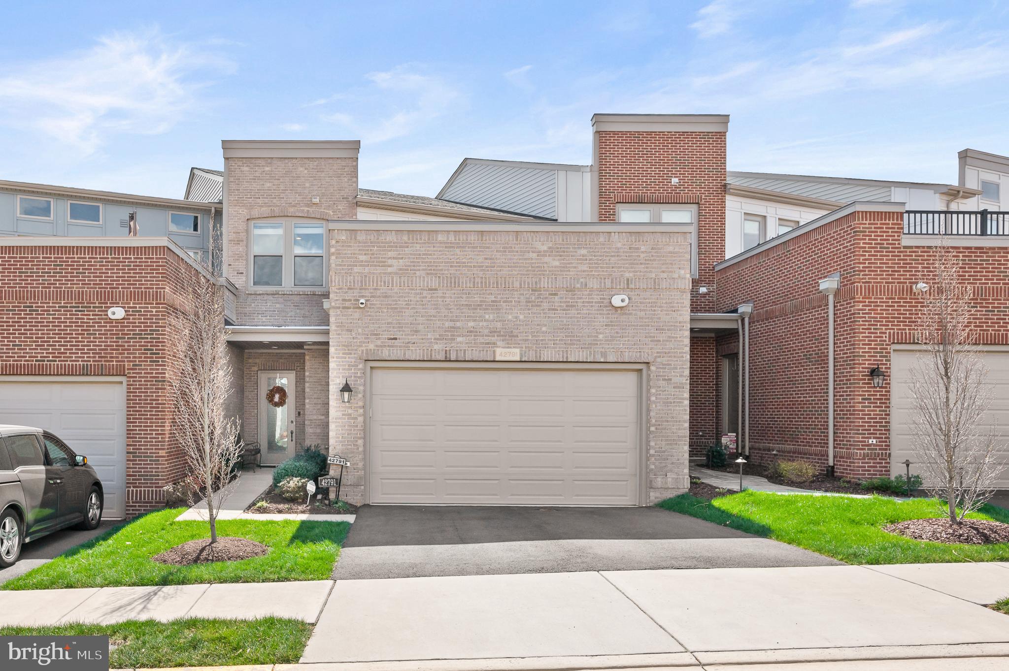 42791 Macbeth Terrace Ashburn, VA 20148 - Photo 52 of 63 a front view of a house with garden