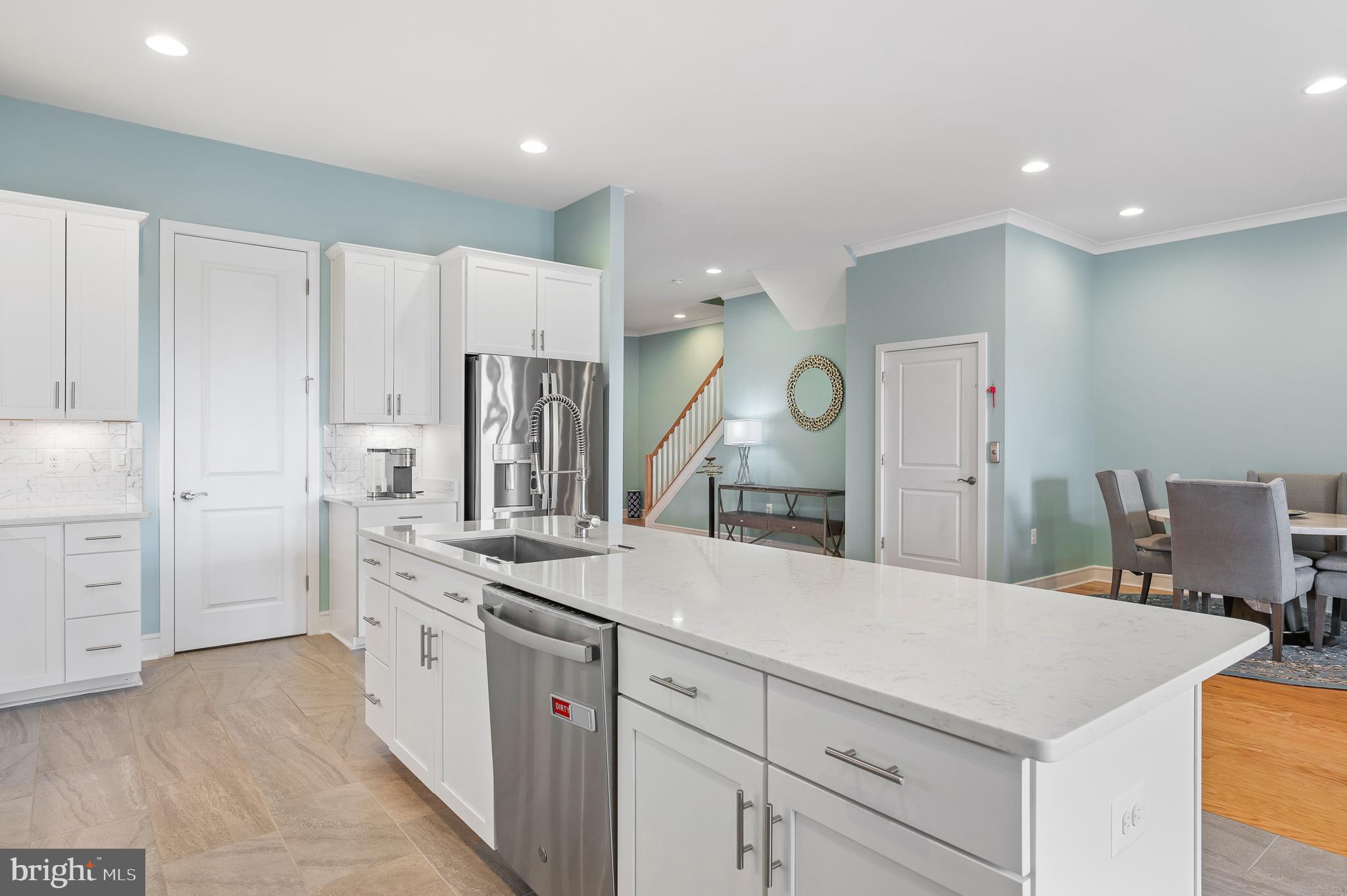 42791 Macbeth Terrace Ashburn, VA 20148 - Photo 6 of 63 a large white kitchen with cabinets and stainless steel appliances