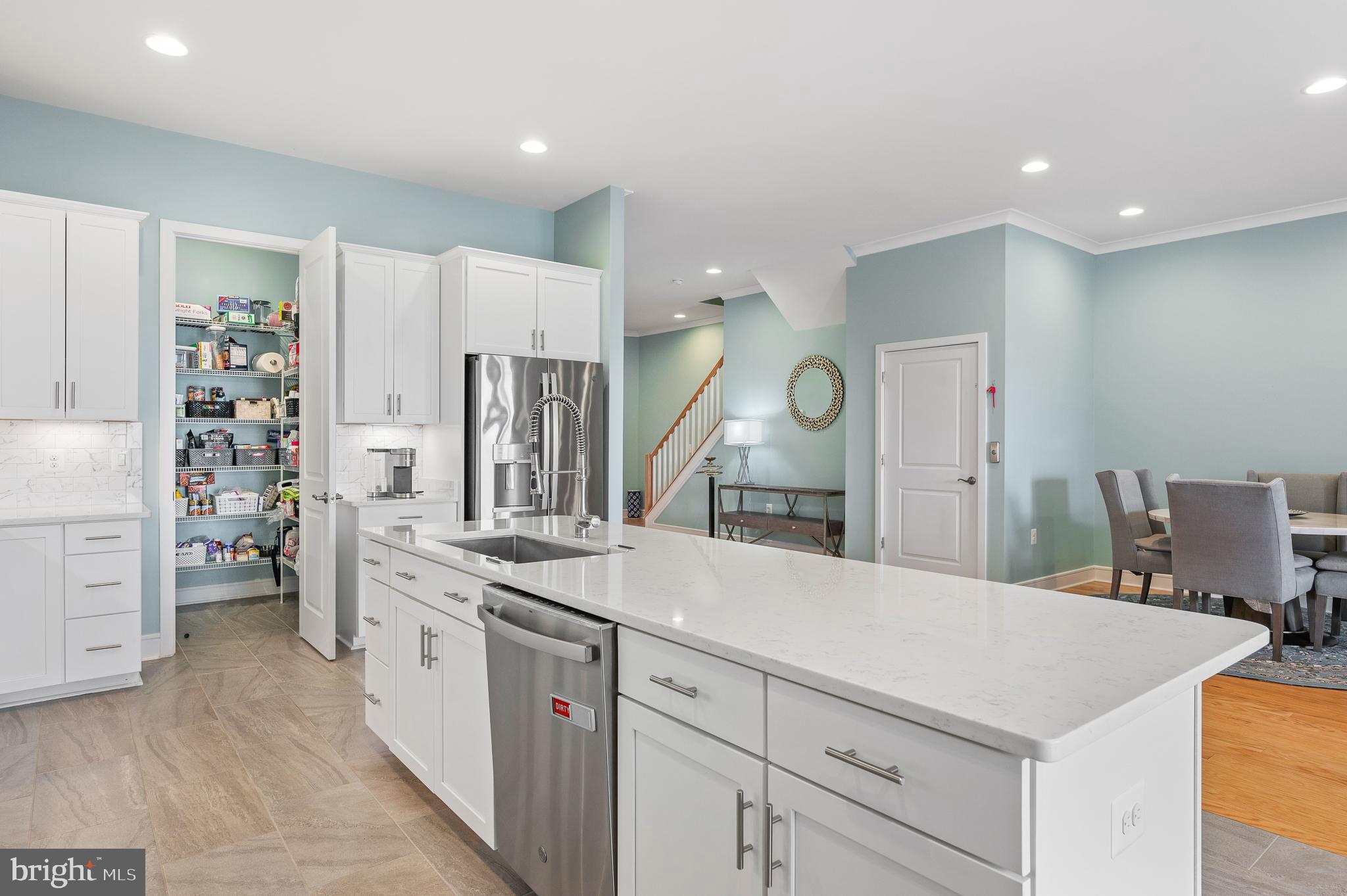 42791 Macbeth Terrace Ashburn, VA 20148 - Photo 7 of 63 a large white kitchen with cabinets