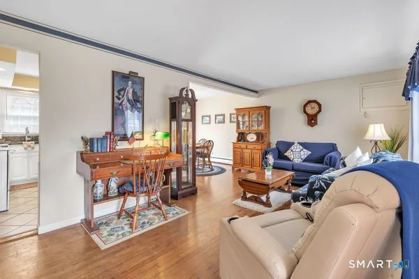 a living room with furniture and wooden floor