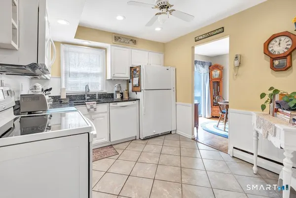 a kitchen with a refrigerator sink and cabinets
