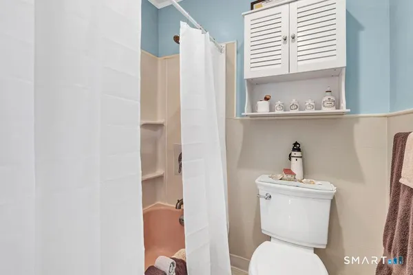 a white toilet sitting next to a bathroom sink