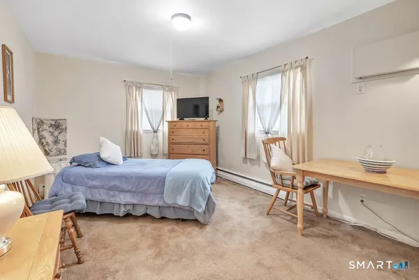 a bedroom with a bed and a desk