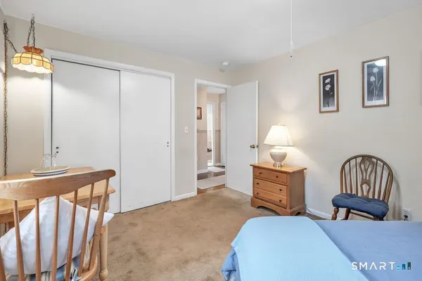 a bedroom with furniture and a window