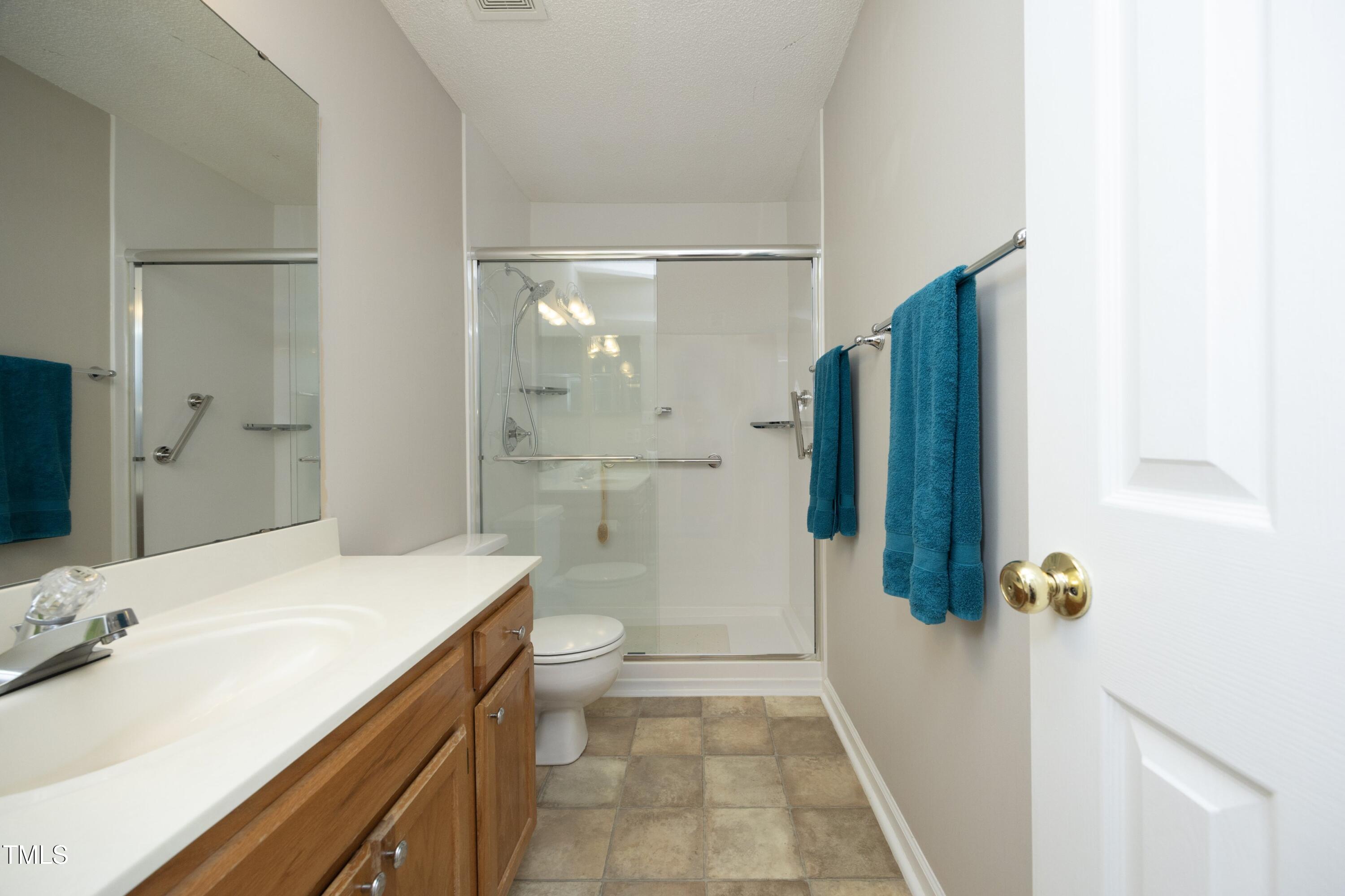 5513 Edgebury Road Raleigh, NC 27613 - Photo 22 of 34 a bathroom with a sink a toilet and shower