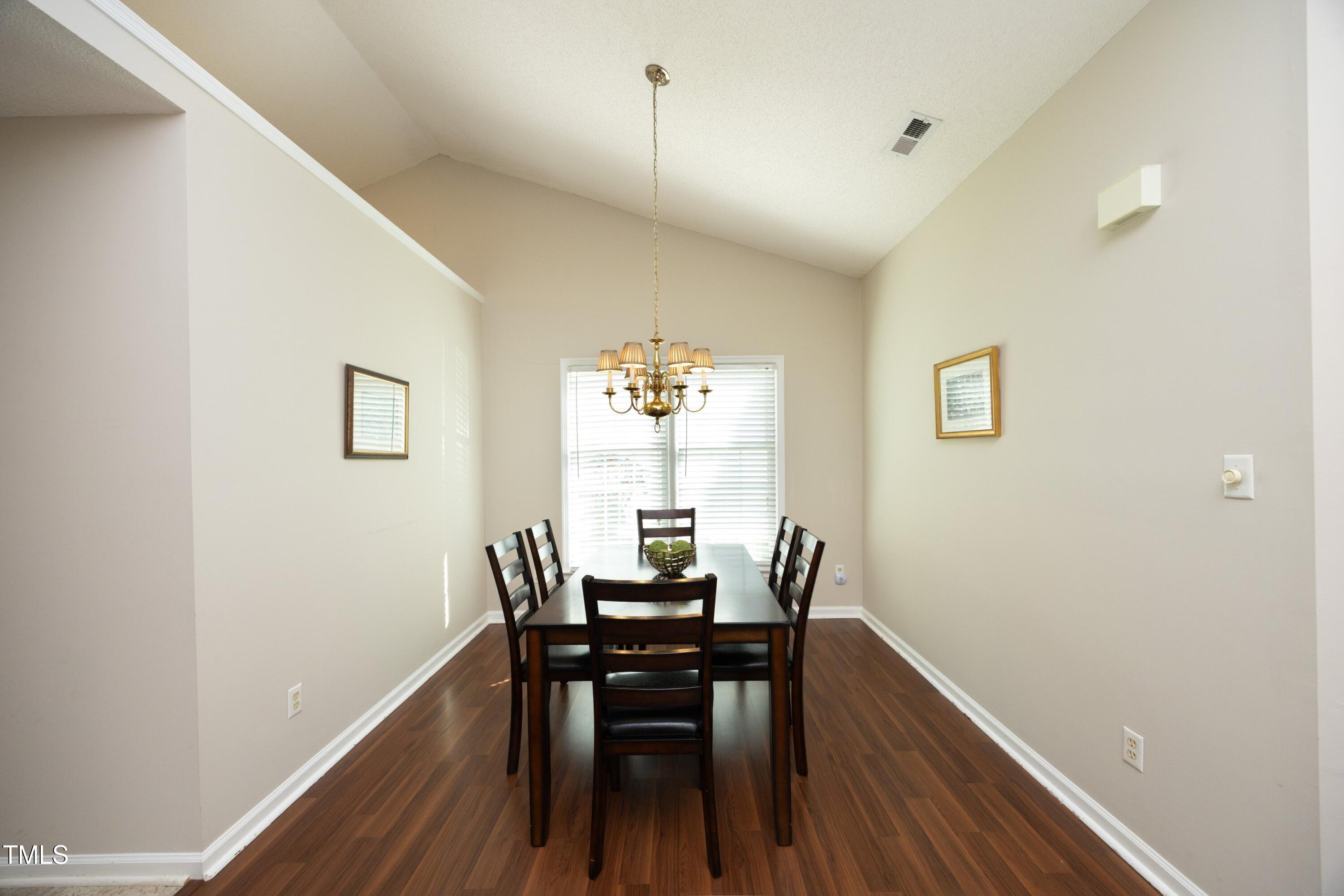 5513 Edgebury Road Raleigh, NC 27613 - Photo 7 of 34 a dining room with furniture and wooden floor