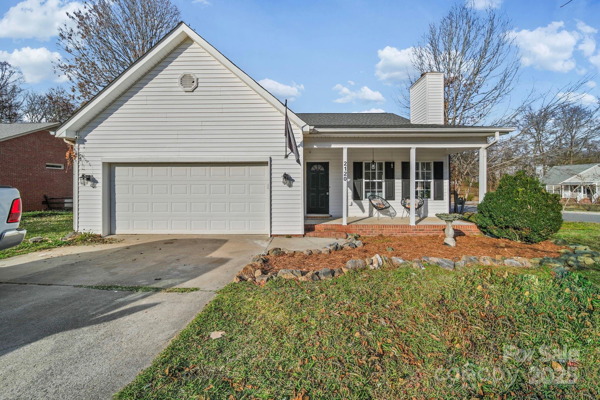 2120 Crosstrail Ridge Rock Hill, SC 29732 - Photo 2 of 12 a front view of a house with a yard and garage