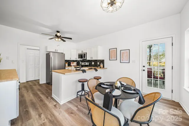 a view of a kitchen area with furniture and wooden floor