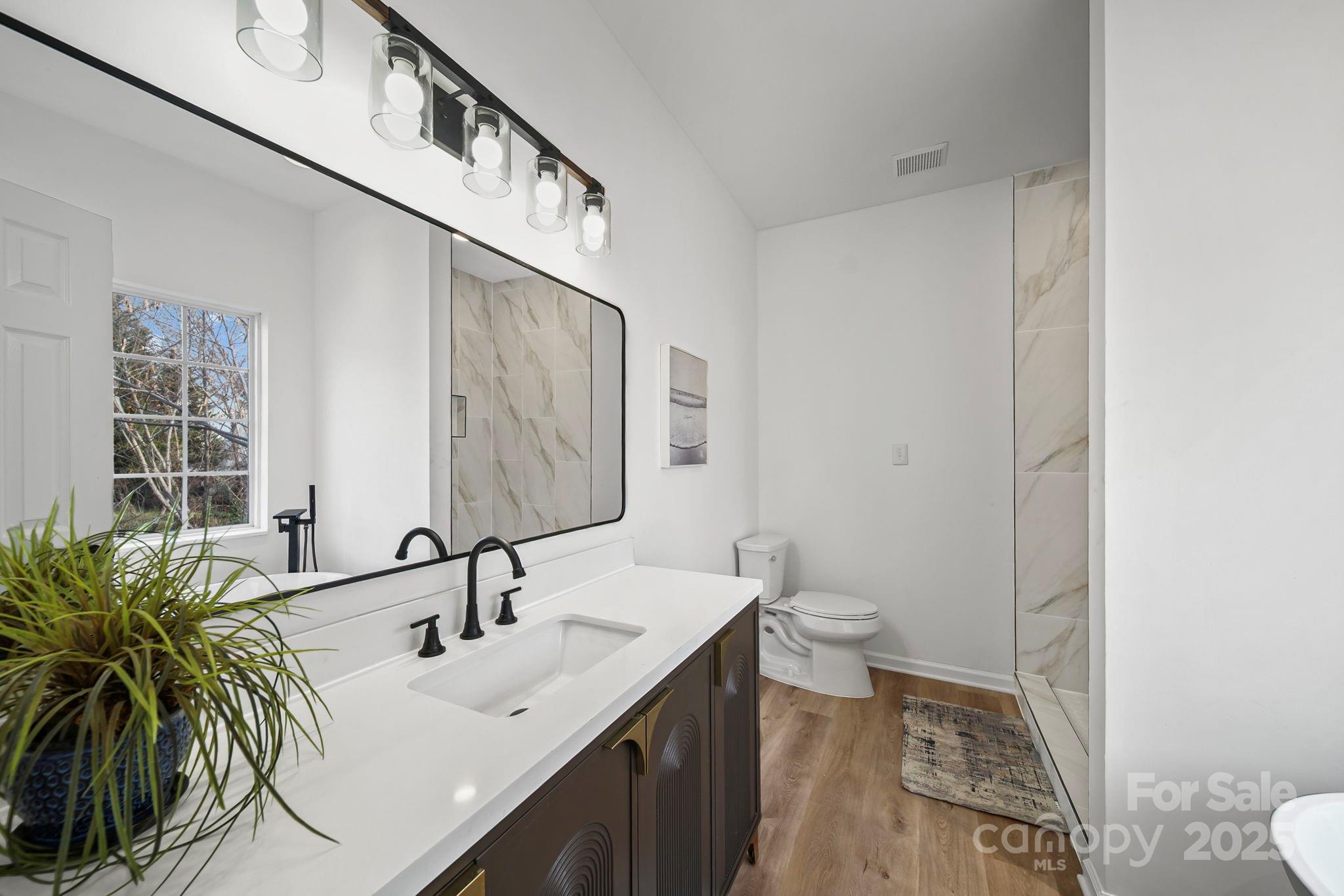 2120 Crosstrail Ridge Rock Hill, SC 29732 - Photo 6 of 12 a bathroom with a sink a toilet and a mirror