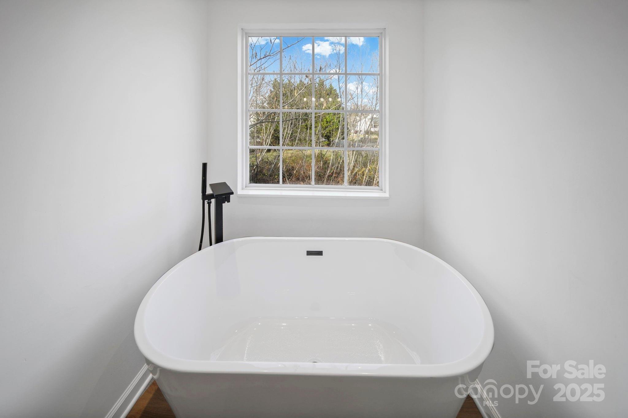 2120 Crosstrail Ridge Rock Hill, SC 29732 - Photo 8 of 12 a white bath tub sitting in a bathroom next to a window