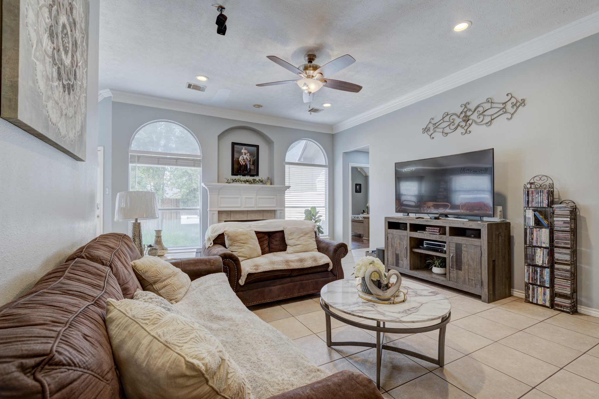 6723 Greenhouse Road Katy, TX 77449 - Photo 6 of 15 a living room with furniture a fireplace and a flat screen tv