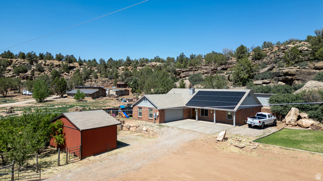 1504 Rome Way Apple Valley, UT 84737 - Photo 19 of 22 Brick residence with an attached garage and solar panels