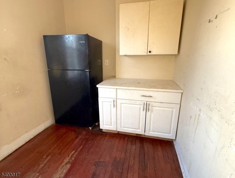 66 Scheerer Avenue Newark, NJ 07112 - Photo 19 of 24 a kitchen with a refrigerator and a stove top oven