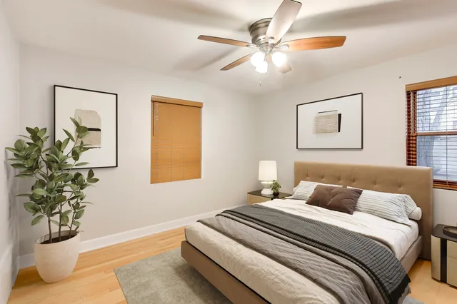 a bedroom with a bed and a potted plant