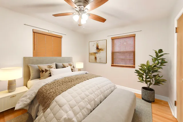 a bedroom with a large bed and a chandelier