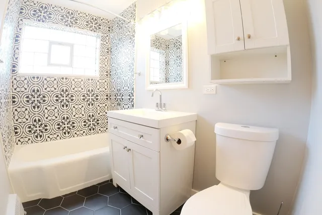 a bathroom with a sink toilet and bathtub