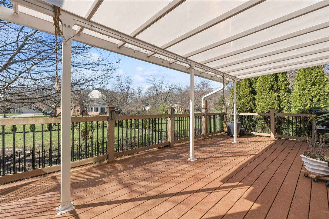 8781 Rupp Farm Drive West Chester, OH 45069 - Photo 48 of 48 This spacious covered deck provides an ideal outdoor living area with a lush green backdrop.
