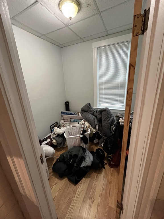 63 Marshfield Street, Unit 1 Boston, MA 02119 - Photo 12 of 26 a bed sitting in a bedroom next to a window