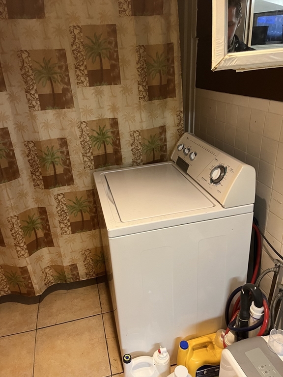 63 Marshfield Street, Unit 1 Boston, MA 02119 - Photo 22 of 26 a utility room with dryer and washer