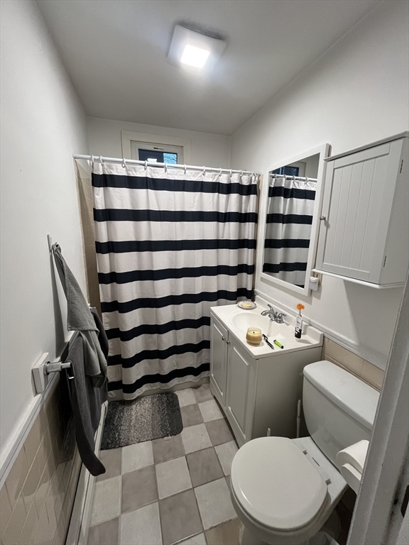 63 Marshfield Street, Unit 1 Boston, MA 02119 - Photo 24 of 26 a bathroom with a sink a toilet and shower