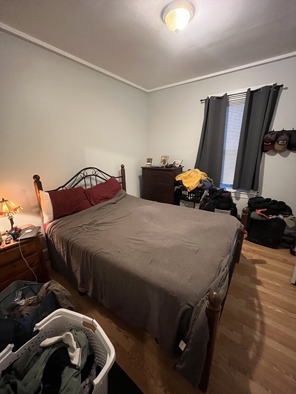 63 Marshfield Street, Unit 1 Boston, MA 02119 - Photo 25 of 26 a bedroom with bed and a window