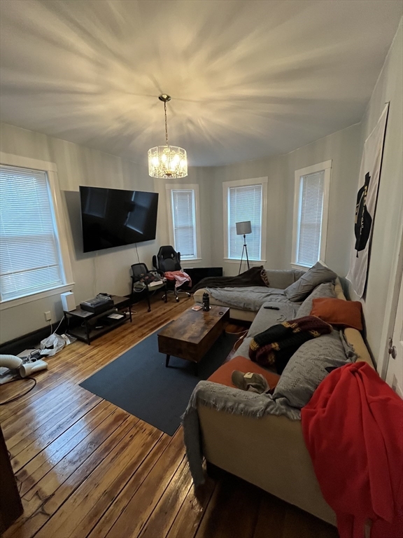 63 Marshfield Street, Unit 1 Boston, MA 02119 - Photo 4 of 26 a living room with furniture and a flat screen tv