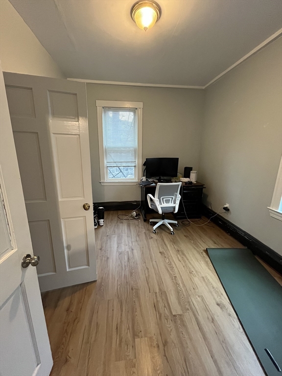 63 Marshfield Street, Unit 1 Boston, MA 02119 - Photo 10 of 26 a living room with furniture and a wooden floor